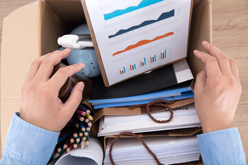 The laid-off employee is packing up personal belongings