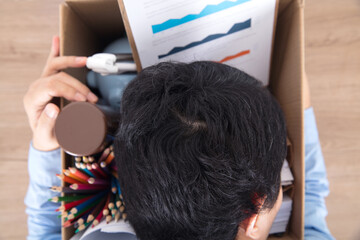 The unemployed employee is lying on the packed items