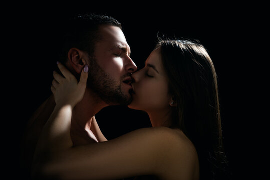 Close-up of young romantic couple is kissing each other.