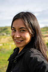 woman with brackets smiling in the field