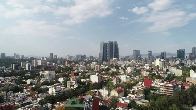Aerial Drone View of Mexico City skyline from condesa Towers and clouds
