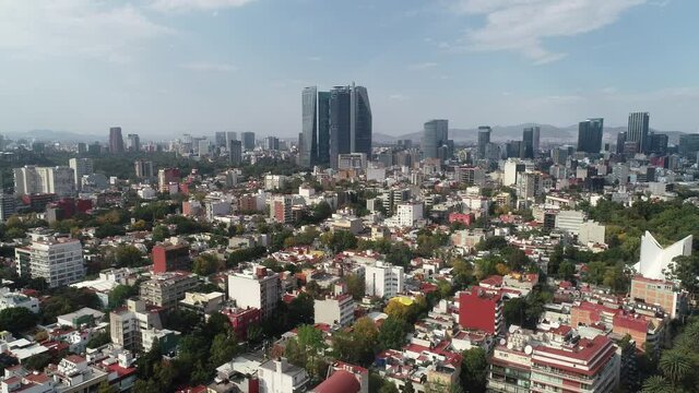 Aerial Drone View of Mexico City skyline from condesa Towers and clouds