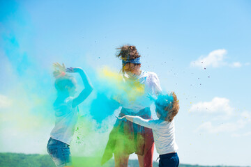 Kids playing with colored splash powder and color dust.