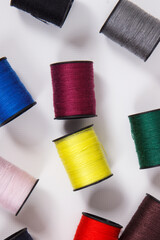 Spools of colorful thread as accessories for using in sewing.