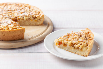 Homemade pie with jam and piece of cake near on plate