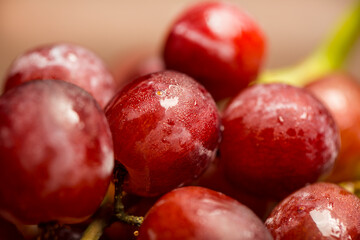 Macro of fresh red delicious vegan organic grapes with water drops