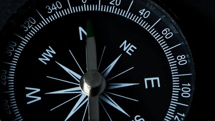 A compass with a green arrow that shows the direction. Concept of travel, adventure, expedition, business, choice and possibilities.