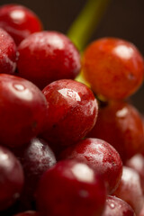 Macro of fresh red delicious vegan organic grapes with water drops