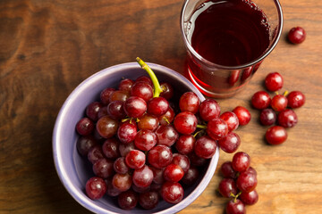 Top view of red delicious vegan organic grapes and grape juice