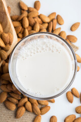 Top view of Fresh organic vegan almond milk. Alternative source of protein for vegetarians, low calories tasty drink. Closeup, white background