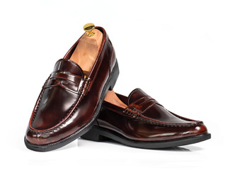 Men fashion brown polished leather collection loafer shoes with shoe tree (shape supporter) isolated on white background.