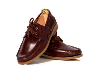 Men fashion brown leather boat shoes with shoe tree (shape supporter)  isolated on white background.
