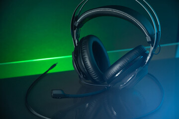 Fototapeta na wymiar Gamer Headphones Dark Background and colorful Light.