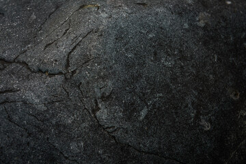 Dark gray stone texture. Industrial design background. Abstract grunge. Old rough black granite surface. Image with copy space.