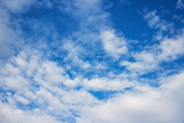 Blue sky background with tiny clouds.