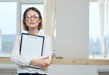 Business woman indoors with document folder white sheet mockup