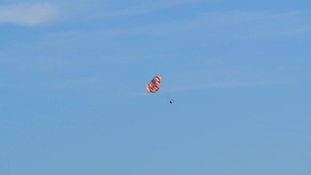 People are resting flying on parasailing in the sky, outdoor activities.