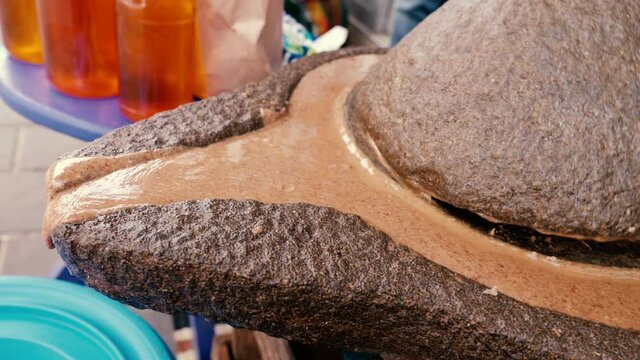 Traditional Moroccan millstone, grinding stone, where almonds are ground, mixed with Argan oil, it becomes Amlou. A famous traditional Moroccan delicacy.