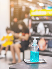 Blue alcohol gel bottle for hands cleaning to prevent the spreading of the Corona virus (Covid-19),Place the entrance service for customers  in the sport store.Healthcare concept.New normal lifestyle.