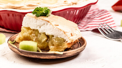 Traditional Swedish cuisine. homemade rhubarb cake with meringue on top, light background, Food recipe background. Close up