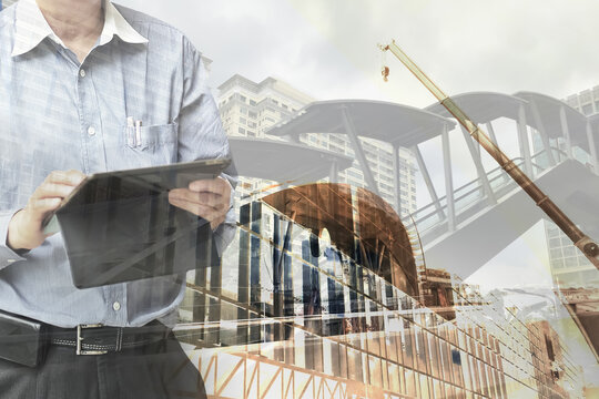 Real estate developer architect use tablet to control and manage construction industry plan for business investor with architecture urban background. - Powered by Adobe