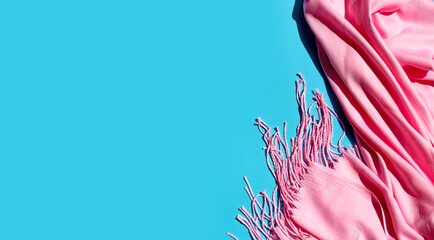Pink women's shawl on blue background.