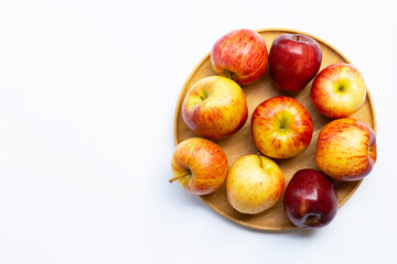 Fototapeta na wymiar Fresh juicy apples on wooden plate on white