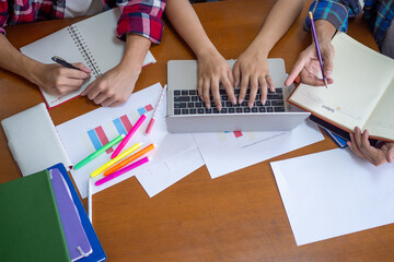 Group of students working together on a report or homework assignment and discovering different...