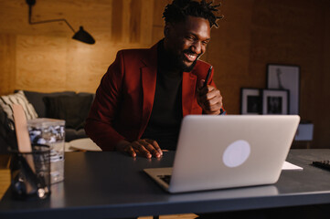 Confident young african man look at webcam conference video calling in office, happy mixed race...