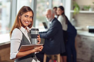 business woman holding a cup of coffee and files
