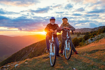 Active Senior Couple Riding Bikes In Park