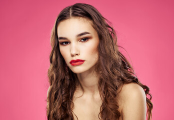 Fototapeta premium Pink background female portrait bared shoulders red lips