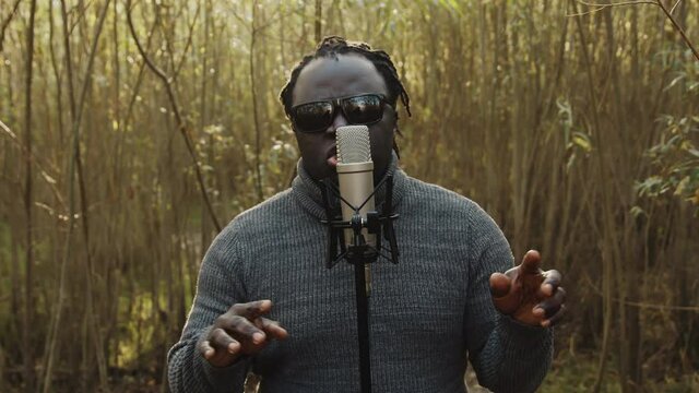 Young affrican man singing in the nature