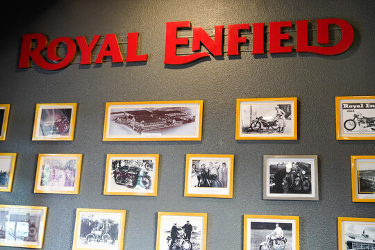 Royal Enfield motorcycle decoration frames wall in interior dealership shop of vintage indian motorbike