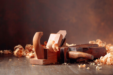 Old wooden jointers and shaving on wooden table.