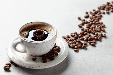 A drop of coffee fall in a cup.