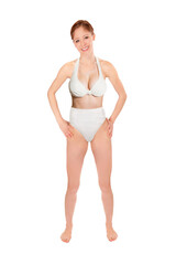 Fototapeta premium Full length portrait of a beautiful young woman wearing a white bikini, isolated on neutral studio background