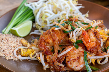 Pad Thai, Traditional stir-fried rice noodle dish commonly served as a street food and at most restaurants in Thailand as part of the country's cuisine. Stir fry noodles with sweet savoury sour sauce.