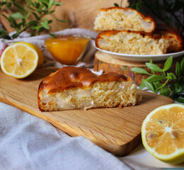 Slice of honey Apple pie on a wooden Board with lemon