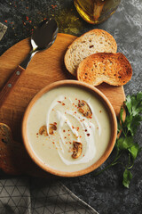 Concept of tasty lunch with bowl of mushroom soup on black smoky background