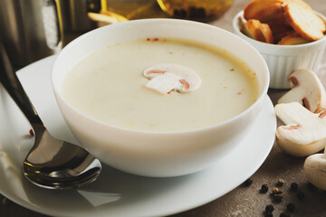 Concept of tasty lunch with bowl of mushroom soup on gray background