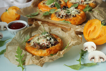 Rustic pastries with mushrooms and meat and decorated with cheese close-up