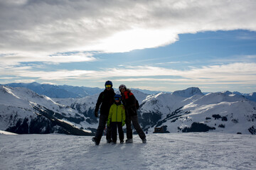 Naklejka na ściany i meble Family, skiing in winter ski resort on a sunny day, enjoying nature