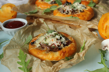Home-baked bun with meat and mushrooms is decorated with cheese