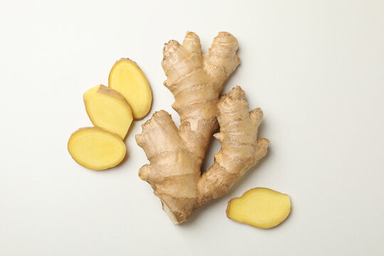 Fresh raw ginger and slices on white background