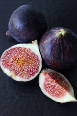 Purple Fig slices on a dark background close-up.Texture or background