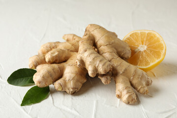 Fresh raw ginger and lemon on white background