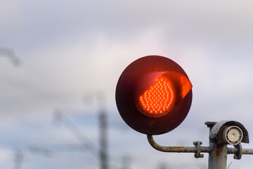 Red light at the traffic light at the railway crossing. Close up.