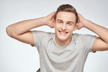 man in gray t-shirt emotions light background cropped view