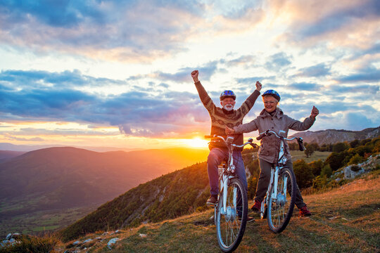 Happy senior couple on their bike. Bicycle, activity. Celebrating